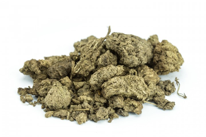 pile of dry cow manure isolated on white background