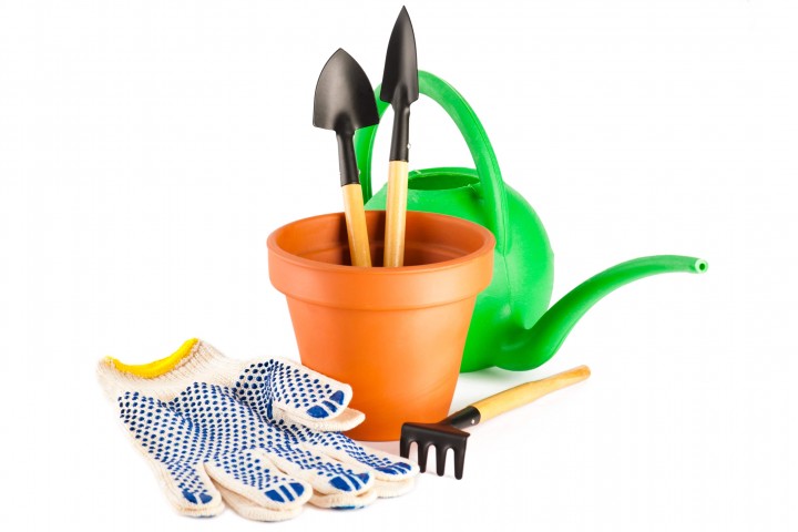 garden tools clay flower pot and gloves isolated on white background