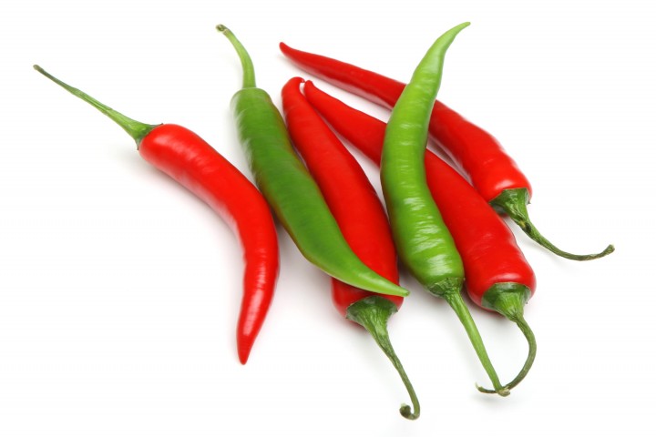 red and green chilli peppers on white background